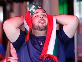Aurelio Gagliano of Windsor was in agony watching Italy in their World Cup match against Costa Rica at Cafe Diplomatico on College St near Clinton on June 20, 2014. (Michael Peake/Toronto Sun)