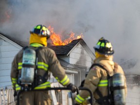 Ottawa Firefighters control a house fire on Kenwood Avenue in the city's west end in 2013. 
Errol McGihon/Ottawa Sun/QMI Agency