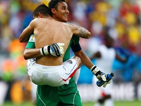 Costa Rica's goalkeeper Keilor Navas and teammate Oscar Duarte celebrate defeating Italy at the end of their 2014 World Cup Group D soccer match at the Pernambuco arena in Recife June 20, 2014. (REUTERS/Dominic Ebenbichler)