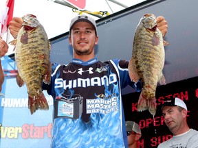 Champion Chris Johnston of Peterborough shows off some of the fish he caught on Lake Ontario during the Canadian Open of Fishing weigh-in at Confederation Park on July 27 2013. (Ian MacAlpine/The Whig-Standard)