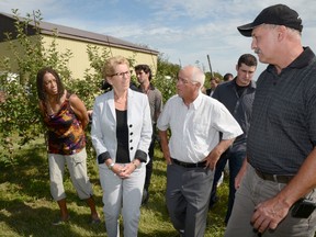 Ontario Premier and Minister of Agriculture Kathleen Wynne, second from left, is pictured during a visit to Grills Orchards in Quinte West, just west of Belleville, in this Aug. 12, 2013 file photo. (QMI Agency files)
