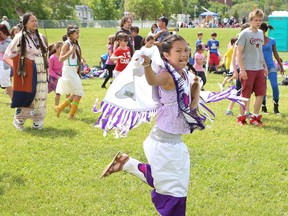 Hope Osawamick, middle, of Cyril Varney Public School, dances at a powwow hosted by the N'Swakamok Native Friendship Centre at Ecole secondaire Sacre-Coeur on Friday. Hundreds of elementary school students from all four school boards attended the event to participate in workshops in dancing, singing, drumming and teepee construction. The event was held to mark National Aboriginal Day on June 21.