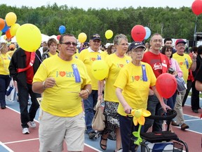 Cancer survivors and family members walk around the Laurentian Community Track to kick off the Relay for Life at Laurentian University on Friday evening. Ben Leeson/The Sudbury Star