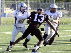 Sudbury Spartans running back Scott Smith (24) braces for a hit while teammate James Howatt (85) attempts to block Oakville Longhorns defender Jamille Edwards during Northern Football Conference action at James Jerome Sports Complex last Saturday. Sudbury won 33-14. 
Ben Leeson/The Sudbury Star