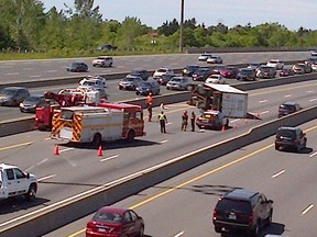 The OPP and Toronto firefighters are on the scene of a truck rollover in the westbound express lanes of Hwy. 401 at Port Union Rd. that occurred around 11 a.m. Saturday. (Chris Doucette-Toronto Sun)