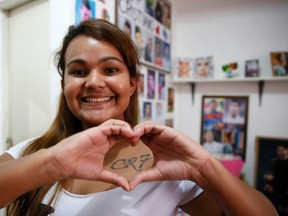 Yasmine Cesar makes the shape of a heart over a "CR7" tattoo, referring to Portuguese striker Cristiano Ronaldo, in her house in Manaus, June 20, 2014. (REUTERS/Andres Stapff)