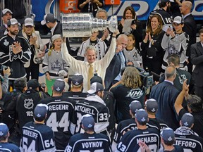 Los Angeles Kings head coach Darryl Sutter hoists the Stanley Cup after defeating the New York Rangers. (USA TODAY SPORTS)