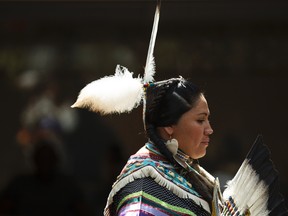 Raylene Hunter, with Heavenly Skies Dance Society, performs a Cree dance at Muttart Conservatory in Edmonton, Alta., on Saturday, June 21, 2014. June 21 is National Aboriginal Day. Ian Kucerak/Edmonton Sun/QMI Agency