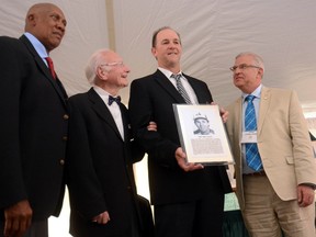 Expos great and Dodgers bench coach Tim Wallach is welcomed into the Canadian Baseball Hall of Fame by Hall of Fame members Ferguson Jenkins and Jim Fanning, from left, and Hall board chair John Starzynski, at right, on Saturday in St. Marys, Ont. (Scott Wishart/QMI Agency)