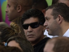 Argetina's former football star Diego Maradona (C) watches the Group F football match between Argentina and Iran at the Mineirao Stadium in Belo Horizonte during the 2014 FIFA World Cup in Brazil on June 21, 2014. (AFP PHOTO / JUAN MABROMATA)