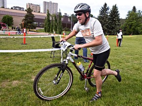 Mark Ringness prepares to transition from his bicycle during the River Valley Offroad Traithlon and Duathlon at the Kinsmen Field House in Edmonton, Alta., on Saturday, June 21, 2014. Codie McLachlan/Edmonton Sun/QMI Agency
