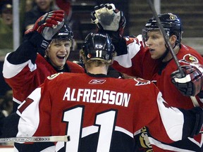 Jason Spezza, Danny Heatley and Daniel Alfredsson celebrate after a goal by Spezza during their 2006 season. OTTAWA SUN FILES