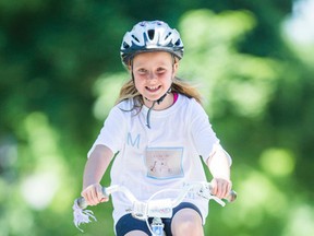 Julia Burkhardt, 7, rides her bike in Toronto on Sunday, June 22, 2014. (Ernest Doroszuk/Toronto Sun)