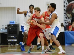 Canada's Ben Miller battles for the ball against Dominican Republic at the FIBA Americas U18 basketball championships, Saturday in Colorado Springs, Colo. (GARRETT W. ELLWOOD/FIBA)