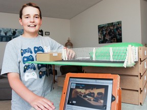 Bradley Wood-MacLean, a Grade 6 student at Welborne Avenue Public School, poses with his heritage fair model and video of the Diefenbunker in his west-end Kingston home on Sunday. Nominated as a Young Citizen, he is one of 150 students across Canada competing to win a trip to Ottawa to screen the videos they made showcasing their interest in Canadian Heritage. Wood-MacLean's video is a virtual tour of the Canadian cold war bunker, the Diefenbunker, at Canada Forces Station Carp. (Julia McKay/The Whig-Standard)