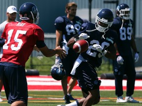 Argonauts quarterback Ricky Ray hands off to running back Curtis Steele during practice at York University on Sunday. Steele 
is one of numerous backs kept on by the Scullers as cut-down day sailed by. Veteran receiver Romy Bryant was let go, however. (DAVE THOMAS/TORONTO SUN)
