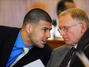 Former NFL New England Patriots football player Aaron Hernandez talks with his defense attorney, Charles Rankin during a hearing at the Bristol County Superior Court House in Fall River, Massachusetts, June 16, 2014. (REUTERS/Faith Ninivaggi/POOL)