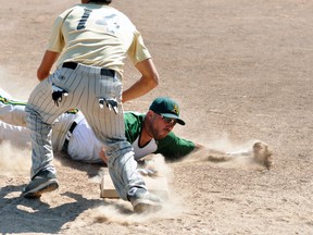 Jeff Van Nynatten of the Mitchell A’s dives safely into third base during the ‘A’ championship game of the Mitchell Coyotes slo-pitch tournament Sunday at Keterson Park. Playing third is Trevor Rose, of the Steelers, who were edged 14-10. ANDY BADER/MITCHELL ADVOCATE