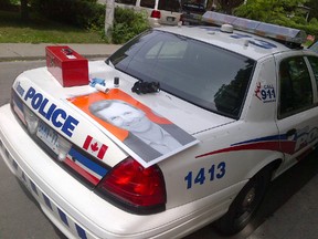 Toronto Police examine one of the damaged signs. (Supplied photo)