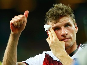 Germany's Thomas Mueller gives a thumbs up while holding his bleeding head after the 2014 World Cup Group G soccer match between Germany and Ghana at the Castelao arena in Fortaleza June 21, 2014. (REUTERS/Eddie Keogh)