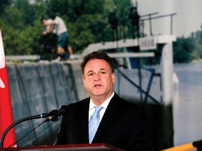 Leeds-Grenville MP Gord Brown, standing in front a backdrop of a lock station, annouces extended operating hours for the Rideau Canal waterway during a press conference in Smiths Falls on Monday. (DARCY CHEEK/The Recorder and Times)