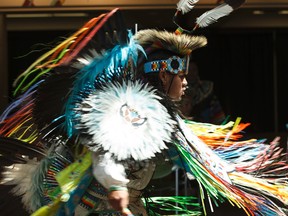 Larson Yellowbird dances during a performance of Cree dances by Heavenly Skies Dance Society at Muttart Conservatory in Edmonton, Alta., on Saturday, June 21, 2014. June 21 is National Aboriginal Day. Ian Kucerak/Edmonton Sun/QMI Agency