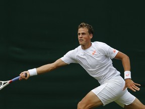 Canada's Vasek Pospisil returns against Netherlands' Robin Haase during their first round singles match at Wimbledon on Monday, June 23, 2014. (Andrew Cowie/AFP)