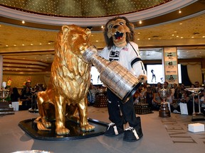 Kings mascot Bailey has a little fun with the Stanley Cup at a display of NHL trophies at the MGM Grand Hotel/Casino yesterday in Las Vegas. The awards will be handed out tonight.