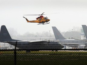 A CH-146 Griffon helicopter from 424 Transport and Rescue Squadron takes off from 8 Wing/CFB Trenton, Ont. next to a C-130H Hercules aircraft last year. - FILE PHOTO BY JEROME LESSARD/THE INTELLIGENCER/QMI AGENCY