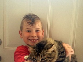 Tallen Caron with his cat Stan that inspired his donation of his eighth birthday money to The Cat Shelter in Kenora.