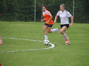 A member of Taggs carries the ball upfield while being chased by a Rush forward during Kenora Women’s Soccer League play on Monday night, June 23.