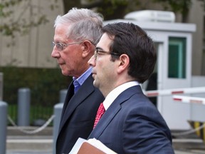 Paul Konigsberg (L), the former accountant and a former senior tax partner at Konigsberg Wolf & Co in New York, leaves the Manhattan federal courthouse after making bail, with his lawyer Reed Brodsky, in New York, Sept. 26, 2013. REUTERS/Zoran Milich
