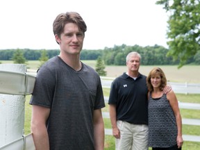 NHL prospect Jared McCann poses for a photo with his parents, Matt and Erin, at their home north of London, Ontario on Sunday June 22, 2014.  The Soo Greyhounds forward is believed to be a top 20 pick in the upcoming NHL draft. (CRAIG GLOVER/The London Free Press/QMI Agency)