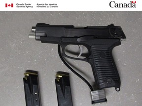 Border officials say they seized this 9mm handgun and two magazines on Saturday. A Texas man has been charged. (CBSA HANDOUT PHOTO)