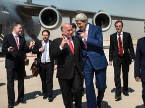 U.S. Secretary of State John Kerry (centre, R) talks with Fuad Hussein (centre,L), chief of staff at the presidency of the Kurdistan Regional Government, while accompanied by Kurdish regional foreign relations minister Falah Mustafa Bakir (R) and other officials, at Arbil International Airport  June 24, 2014. REUTERS/Brendan Smialowski/Pool
