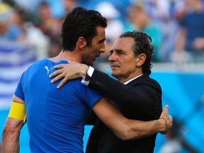 Italy's goalkeeper Gianluigi Buffon and coach Cesare Prandelli hug after their World Cup 1-0 loss to Uruguay at the Dunas arena in Natal, Brazil on Tuesday, June 24, 2014. Prandelli offered his resignation following the match. (Yves Herman/Reuters)