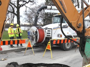 City crews were on site of a large sinkhole that closed the southbound lanes of St. Mary's Road near Morier Avenue in the Glenwood area last month. The city would have a lot more money to spend on road repairs if they curbed salaries. (Kevin King/Winnipeg Sun file photo)
