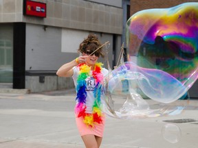 Sarah Michelle Ogden plays with massive bubbles at the Belleville Market Square while informing visitors about the upcoming Pride in the Park event taking place July 5th at West Zwicks.
Lacy Gillott/TheIntelligencer/QMI Agency