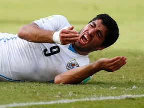Uruguay's Luis Suarez reacts after clashing with Italy's Giorgio Chiellini during their 2014 World Cup Group D soccer match at the Dunas arena in Natal June 24, 2014. (REUTERS/Tony Gentile)