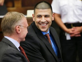Former Patriots tight end Aaron Hernandez smiles while speaking with his defence attorney Charlie Rankin before a hearing in Boston on Tuesday, June 24, 2014. (Steven Senne/Reuters/Pool)