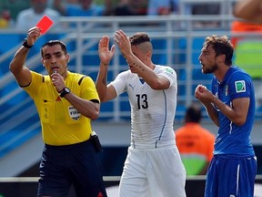 Italy's Claudio Marchisio (R) reacts after referee Marco Rodriguez of Mexico (L) shows him a red card during their 2014 World Cup Group D soccer match against Uruguay at the Dunas arena in Natal June 24, 2014. (REUTERS/Toru Hanai)