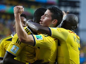 Colombia's Jackson Martinez celebrates with James Rodriguez after scoring his second goal during the 2014 World Cup Group C soccer match between Japan and Colombia at the Pantanal arena in Cuiaba June 24, 2014. (REUTERS/Eric Gaillard)