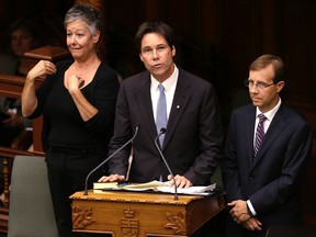 Dr. Eric Hoskins reads the oath at the swearing in ceremony as health minister at Queen's Park in Toronto on Tuesday, June 24, 2014. (Craig Robertson/Toronto Sun)