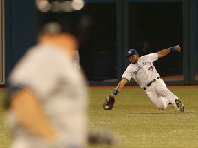 Toronto Blue Jays’ Melky Cabrera can't seem to get his mit around the ball at the Rogers Centre in Toronto, Ont. on Tuesday June 24, 2014. (Dave Thomas/QMI Agency)