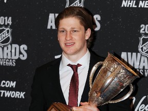 Nathan MacKinnon of the Colorado Avalanche poses with the Calder Trophy after winning the award for NHL rookie of the year on Tuesday night. (Stephen R. Sylvanie/USA TODAY Sports)