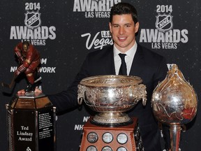 Penguins captain Sidney Crosby poses with Ted Lindsay Award, the Art Ross Trophy, and the Hart Trophy on Tuesday night at the NHL Awards ceremony in Las Vegas. (Stephen R. Sylvanie/USA TODAY Sports)