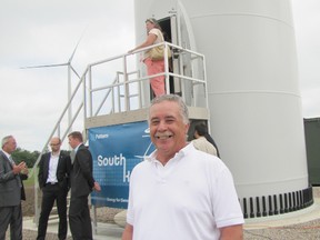 Bryan Prince poses at the base of Turbine 64, where the opening ceremony took place for the South Kent Wind project on June 25. The turbine sits on land that has been farmed for generations by the Prince family.