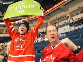 Hockey fans Kaden (l) and dad Shane Sutyla cheer on Canada during the World Under 17 Hockey Challenge in Winnipeg Tuesday January 04, 2011. Sarnia's hockey fans will have their chance to cheer on Canada's players as it is expected Tourism Sarnia Lambton will be announcing that Sarnia will host the U17s this upcoming November at a press conference next week. (OBSERVER FILE PHOTO)