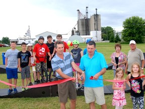 Grant Jones, left, of the Green Lane Trust Fund and Dutton/Dunwich Mayor Cameron McWilliam cut the ribbon at the opening of the new pump track last week. Green Lane granted Dutton/Dunwch $20,000 to help pay for the track, one of the first installed in Canada.
