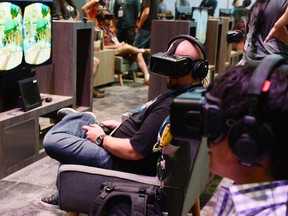 An attendee tries on the Oculus VR Inc. Rift Development Kit 2 headset at the 2014 Electronic Entertainment Expo (E3) in Los Angeles,  June 11, 2014.  REUTERS/Kevork Djansezian